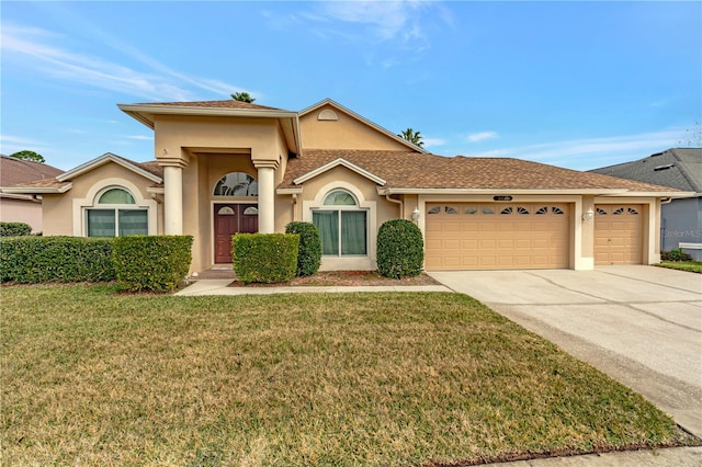 view of front of property featuring a garage and a front lawn