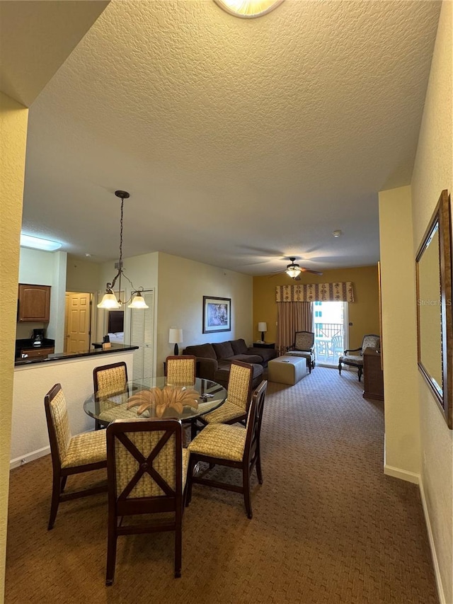 carpeted dining area featuring a textured ceiling