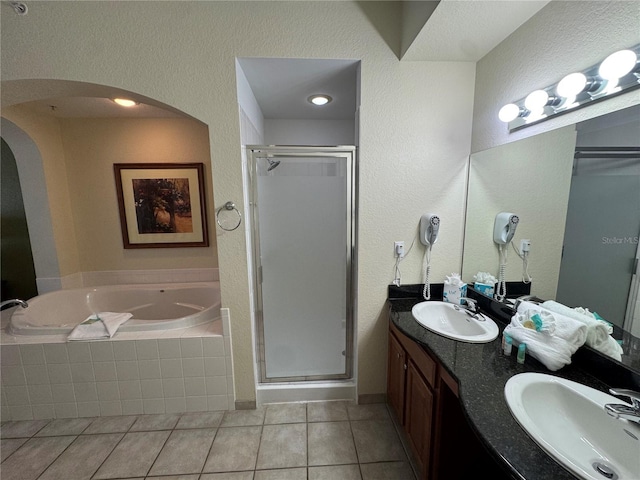 bathroom featuring tile patterned floors, independent shower and bath, and vanity