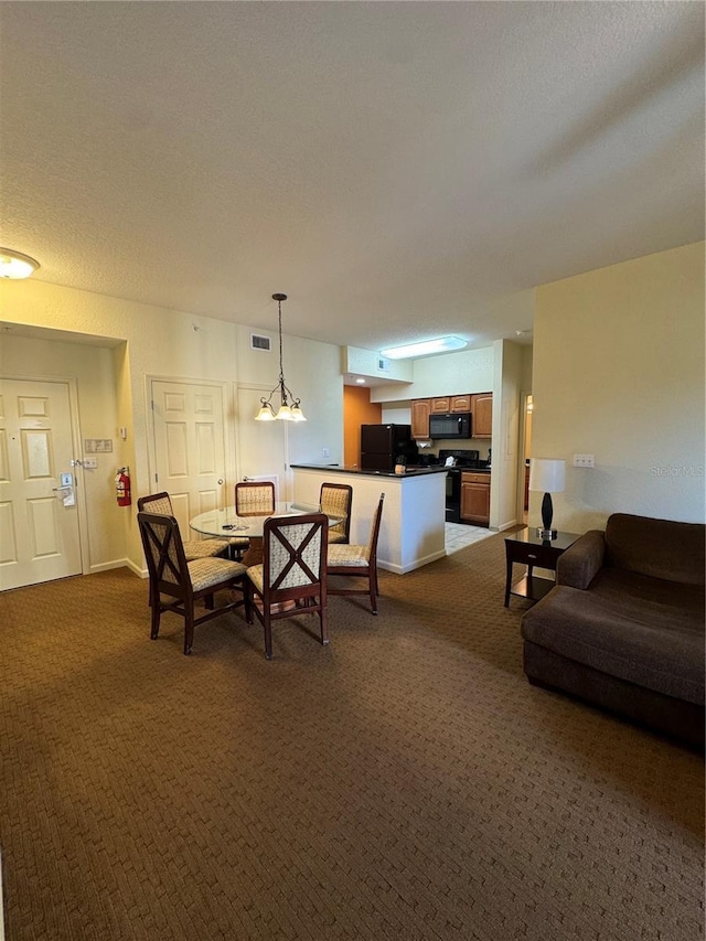 dining space with a textured ceiling and dark colored carpet