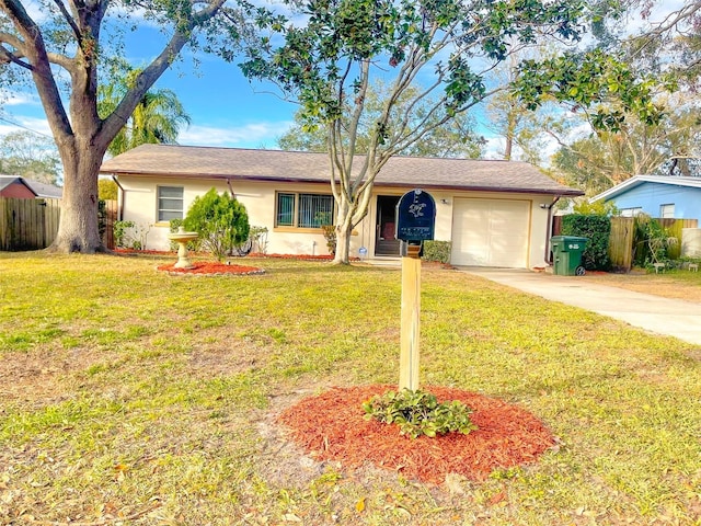 ranch-style home featuring a garage and a front lawn