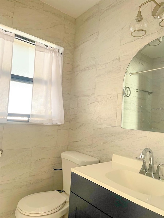 bathroom featuring vanity, toilet, a shower with shower curtain, and tile walls