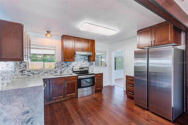 kitchen featuring dark hardwood / wood-style floors, tasteful backsplash, sink, light stone counters, and stainless steel appliances