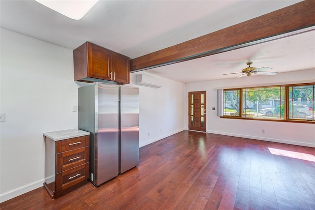 kitchen featuring baseboards, a wall mounted air conditioner, beam ceiling, freestanding refrigerator, and dark wood-style floors