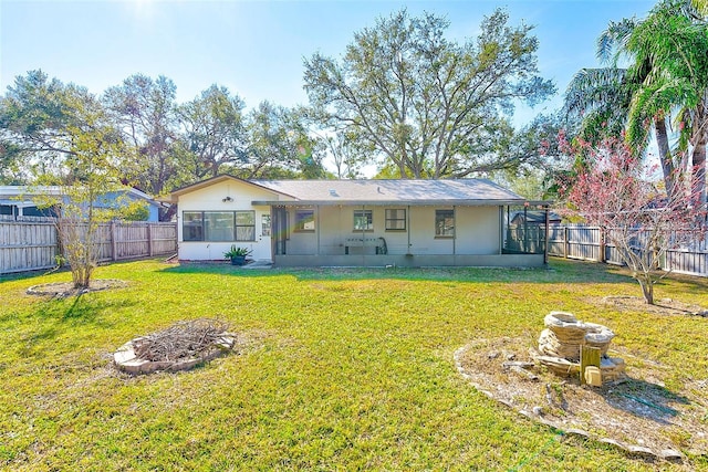back of property featuring a yard and a fenced backyard