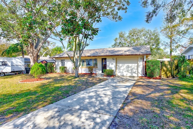 ranch-style home with a garage and a front lawn