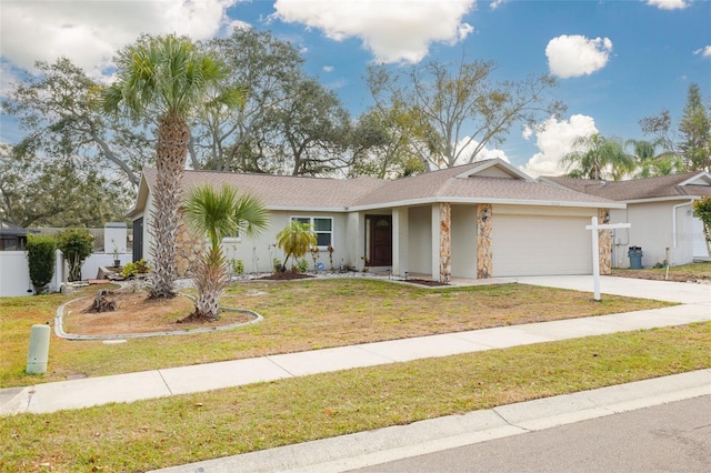 ranch-style house featuring a garage and a front yard