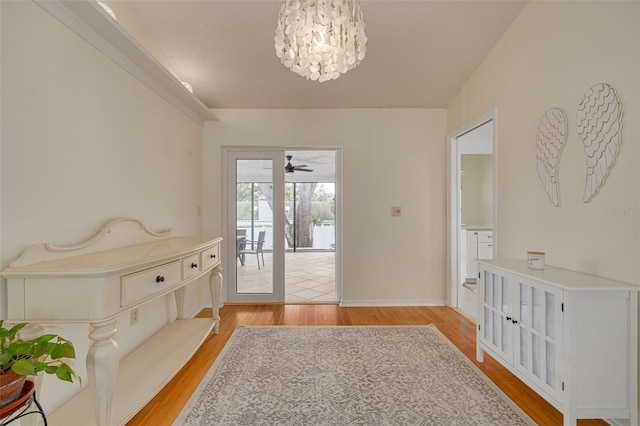 entryway with light hardwood / wood-style floors and a chandelier