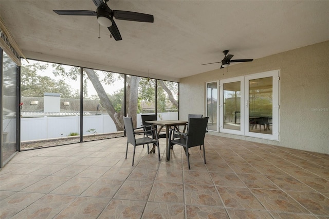 sunroom / solarium with ceiling fan and french doors