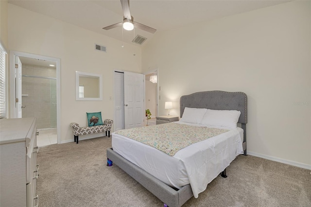 bedroom featuring connected bathroom, high vaulted ceiling, light carpet, a closet, and ceiling fan