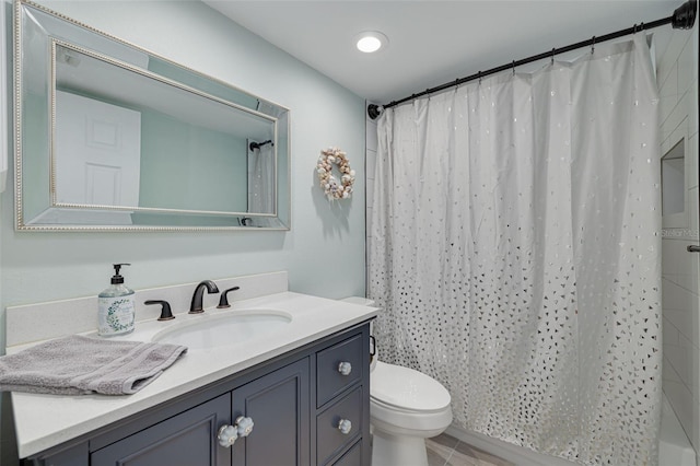 bathroom featuring walk in shower, vanity, and toilet