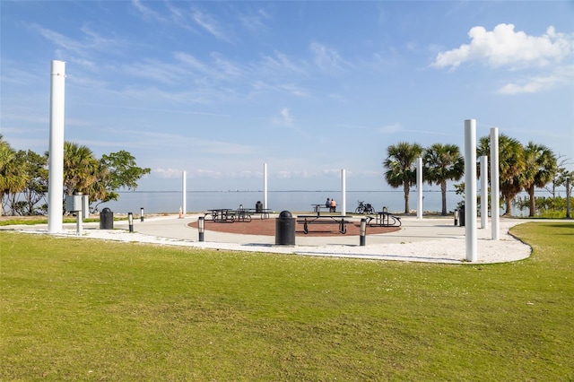 view of home's community featuring a water view and a lawn