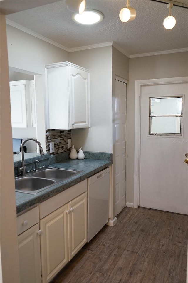 kitchen featuring sink, crown molding, white cabinetry, dark hardwood / wood-style floors, and white dishwasher