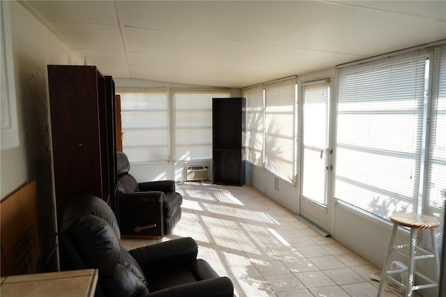 sunroom / solarium featuring vaulted ceiling and a wall mounted AC