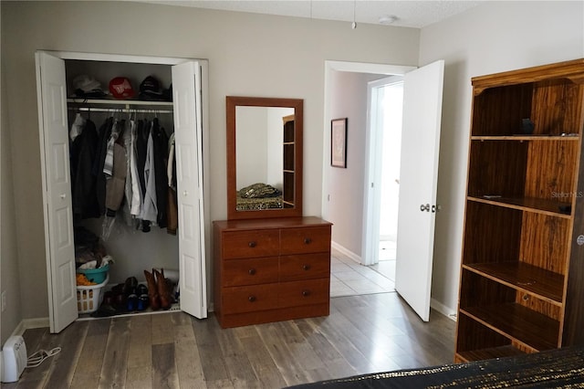 bedroom featuring wood-type flooring and a closet