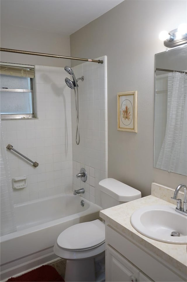 full bathroom with vanity, shower / tub combo, and toilet