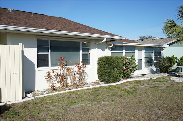 view of property exterior with a yard