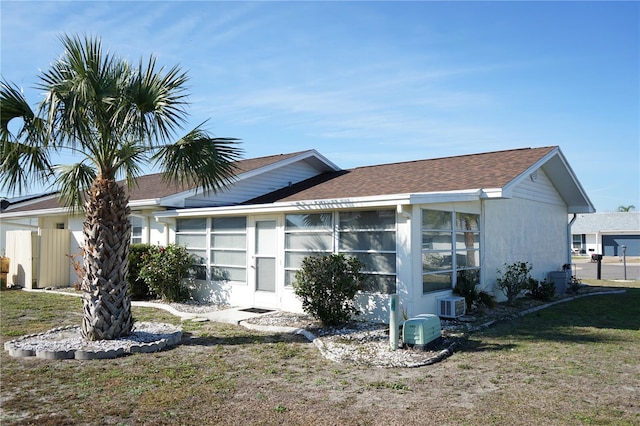 view of home's exterior featuring a yard and a sunroom