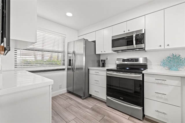 kitchen featuring stainless steel appliances and white cabinets