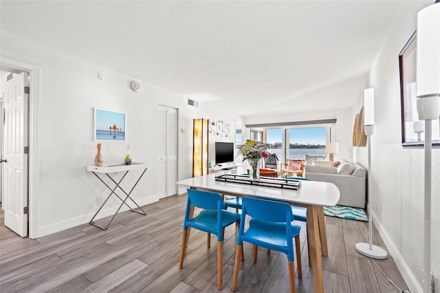 dining space with light hardwood / wood-style flooring