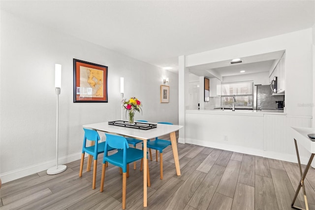 dining area with light wood-type flooring