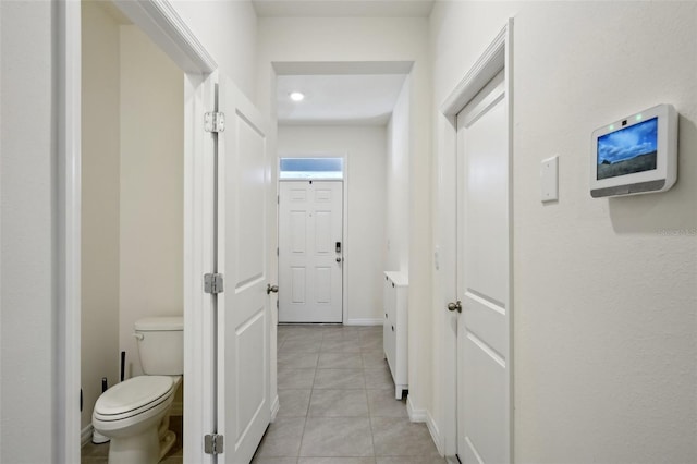 hall featuring light tile patterned floors