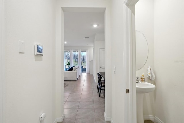 corridor featuring light tile patterned floors