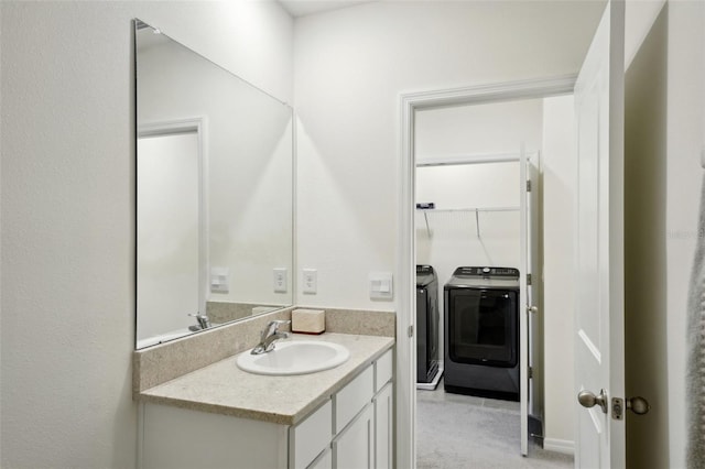 bathroom with vanity and washing machine and dryer