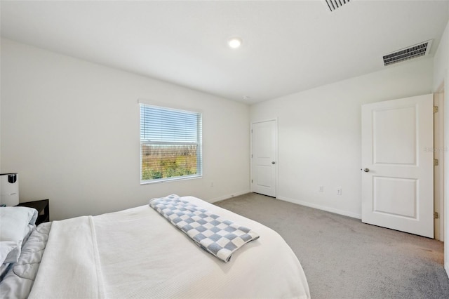 bedroom featuring light carpet