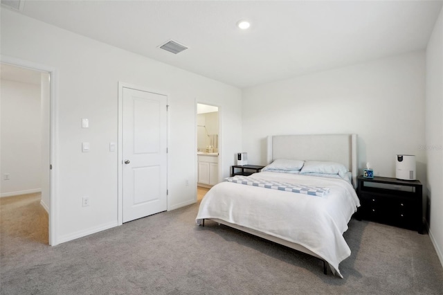 carpeted bedroom featuring connected bathroom