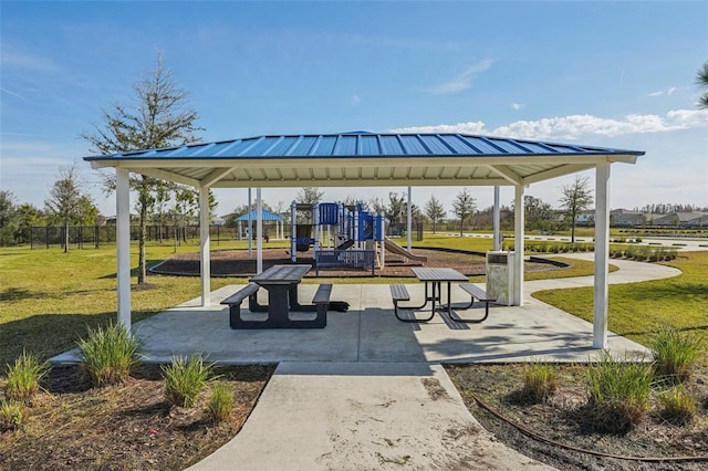 view of home's community featuring a playground and a lawn