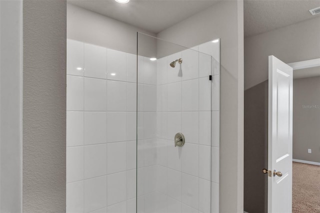 bathroom with tiled shower