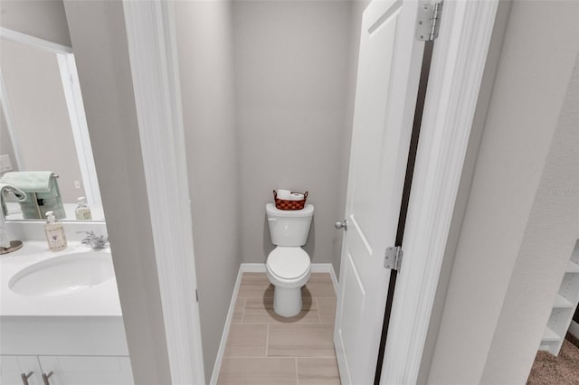 bathroom featuring vanity, tile patterned flooring, and toilet