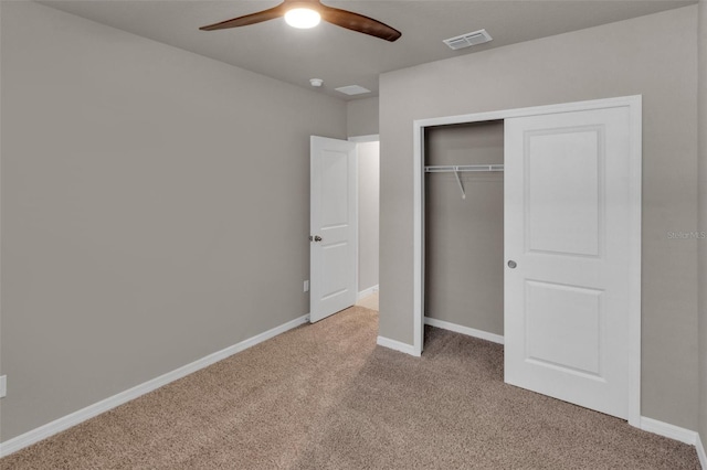 unfurnished bedroom featuring light carpet, a closet, and ceiling fan