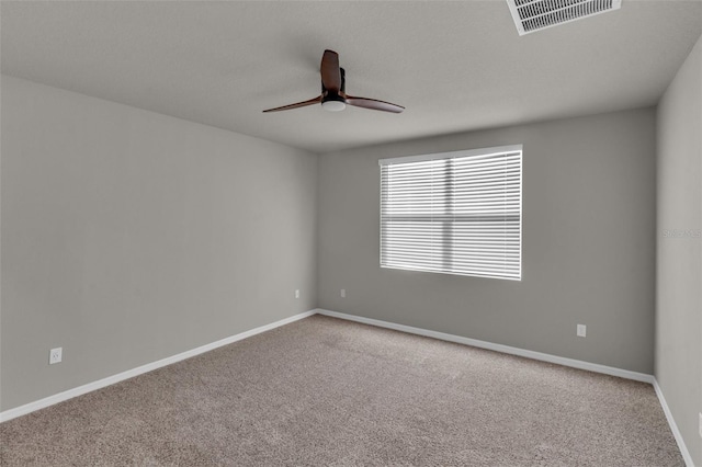 unfurnished room with ceiling fan and carpet flooring