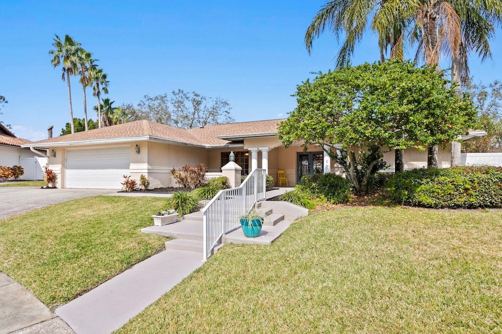 view of front of home with a garage and a front yard