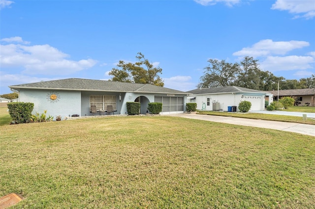 single story home with cooling unit, a garage, and a front lawn