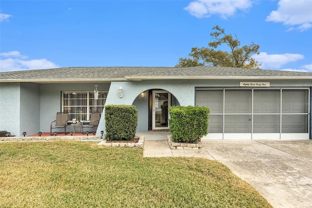 ranch-style home with a garage and a front yard