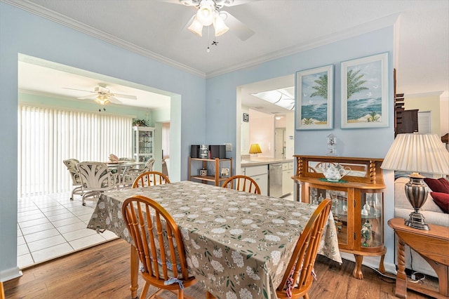 dining room with hardwood / wood-style flooring, ornamental molding, and ceiling fan