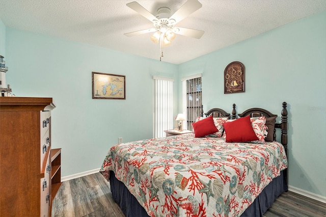 bedroom featuring ceiling fan, dark hardwood / wood-style floors, and a textured ceiling