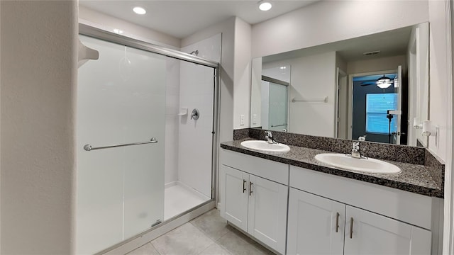 bathroom with tile patterned flooring, vanity, a shower with door, and ceiling fan