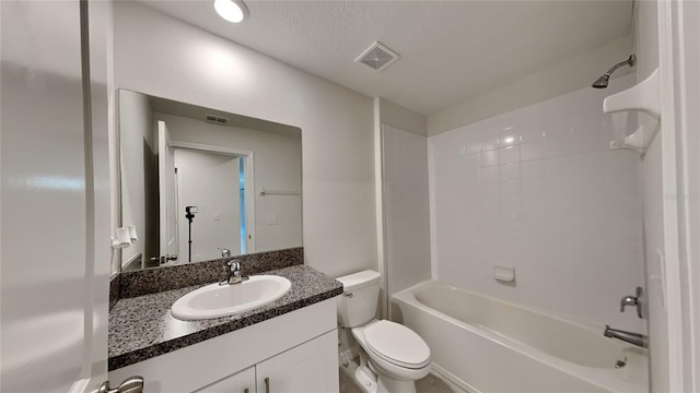 full bathroom with vanity, a textured ceiling, toilet, and washtub / shower combination