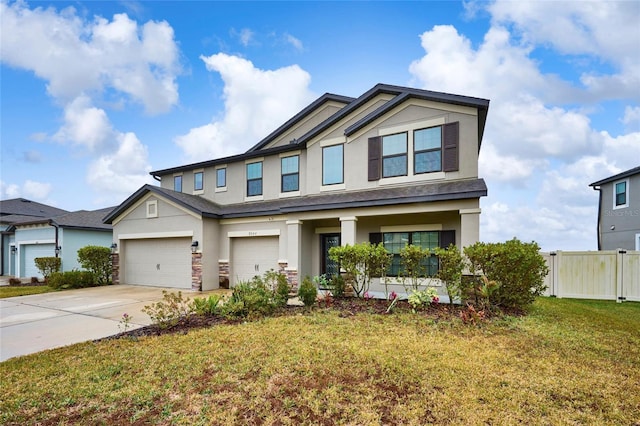 craftsman house featuring a front lawn and a garage