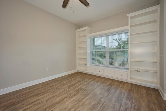 spare room featuring dark wood-type flooring and ceiling fan