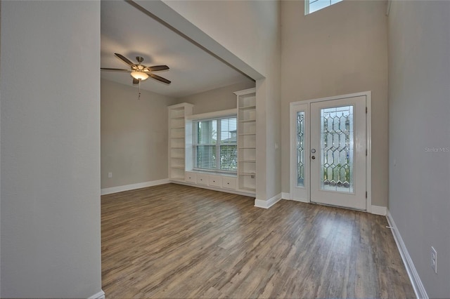 foyer entrance featuring wood-type flooring and ceiling fan