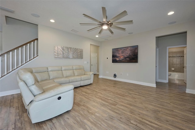 living room featuring hardwood / wood-style flooring and ceiling fan