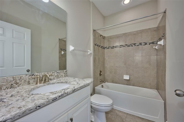 full bathroom with vanity, tiled shower / bath combo, tile patterned floors, and toilet