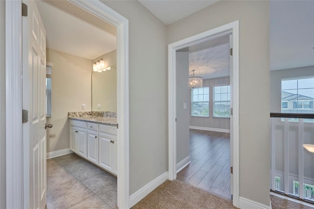 bathroom featuring vanity and an inviting chandelier