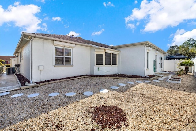 back of property featuring central AC