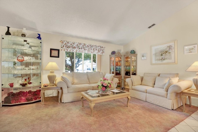 tiled living room with vaulted ceiling and a textured ceiling